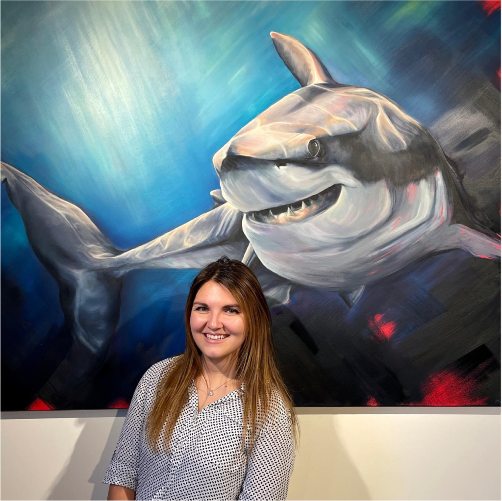 Artist Kayla Due presenting her painting to the AdShark team.
